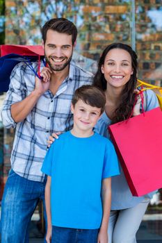 Portrait of a happy family having fun in the mall on a sunny day