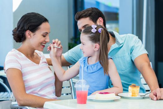 A family eating at the restaurant on a sunny day