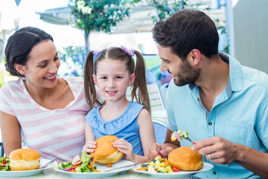 A family eating at the restaurant on a sunny day