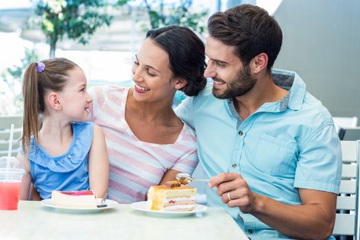 A family eating at the restaurant on a sunny day