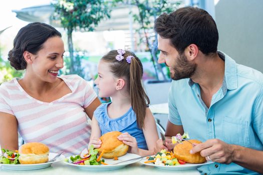 A family eating at the restaurant on a sunny day