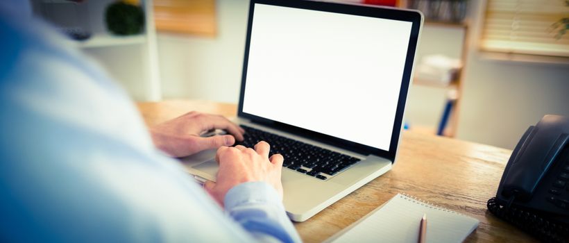 Businessman working on his laptop in his office