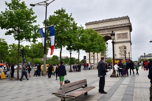 Paris, France - May 14, 2015: Tourist visit Arc de Triomphe de l'Etoile in Paris. Arc de Triomphe was built in 1806-1836 by architect Jean Shalgrenom by order of Napoleon to commemorate victories of his Army.