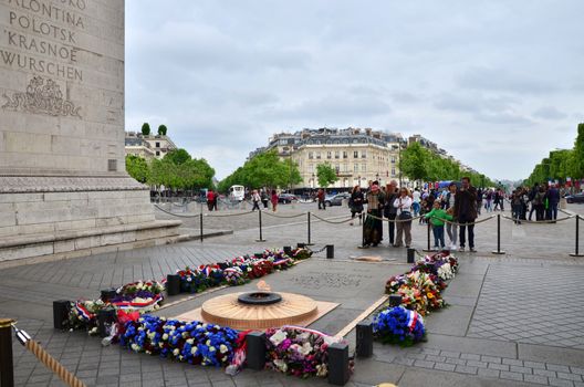 Paris, France - May 14, 2015: Tourist visit Tomb of the Unknown Soldier beneath the Arc de Triomphe, Paris. on May 14, 2015.