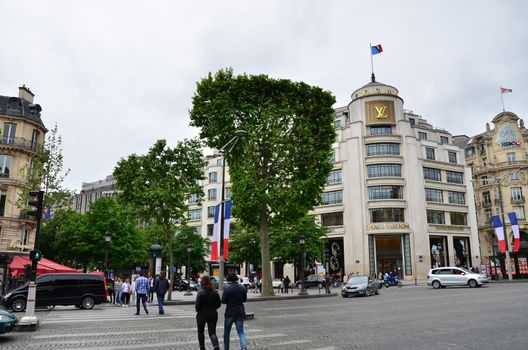 Paris, France - May 14, 2015: Tourists Shopping at Louis Vuitton store on May 14, 2015 in Paris, France. This store is located on the Champs Elyses and offers a wide range of luxury Louis Vuitton clothes and accessories