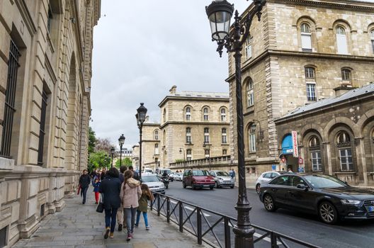 Paris, France - May 14, 2015: French People in Cite Island, Paris, France. on May 14, 2015. It is the centre of Paris and the location where the medieval city was refounded.
