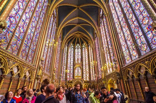 Paris, France - May 14, 2015: Tourists visit Sainte Chapelle (Holy Chapel) in Paris, France. The Sainte Chapelle is a royal medieval Gothic chapel in Paris and one of the most famous monuments of the city.