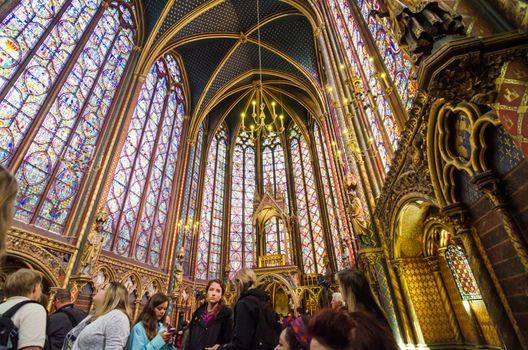 Paris, France - May 14, 2015: Tourists visit Sainte Chapelle (Holy Chapel) in Paris, France. The Sainte Chapelle is a royal medieval Gothic chapel in Paris and one of the most famous monuments of the city.