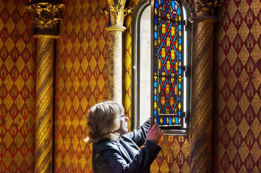 Paris, France - May 14, 2015: Tourist visit Sainte Chapelle (Holy Chapel) in Paris, France. The Sainte Chapelle is a royal medieval Gothic chapel in Paris and one of the most famous monuments of the city.