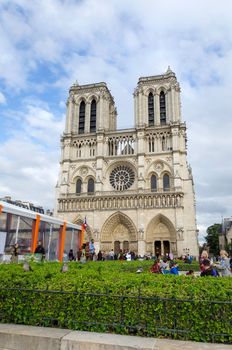 Paris, France - May 14, 2015: Tourists visiting the Cathedral of Notre Dame in Paris, France. on May 14, 2015. Notre Dame is one of the top tourist destinations in Paris.