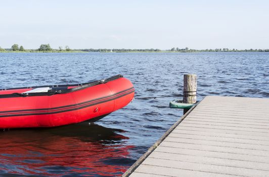 inflatable red boat in the belterwiede lake in holland near giethoorn