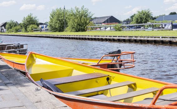 electrical boats waiting in the waters of giethoorn for the tourists to rent