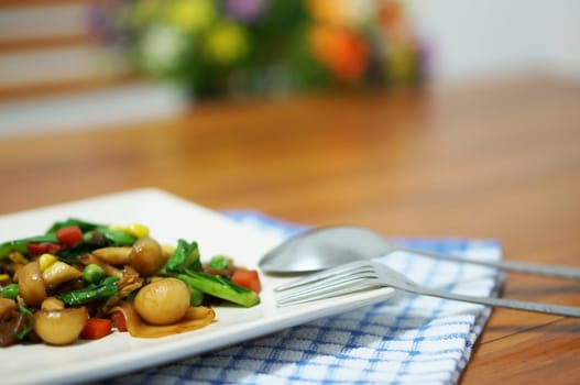 Vegetarian fried noodle with soy sauce in white plate on table.                               