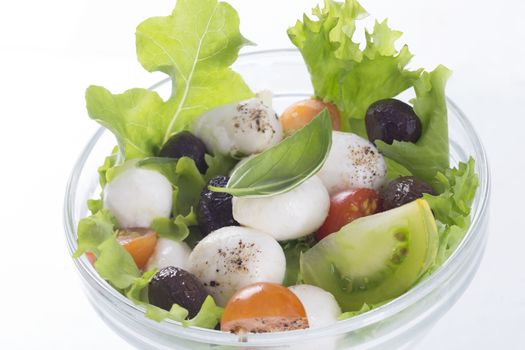 salad with mozzarella, tomatoes bloack olives and basil