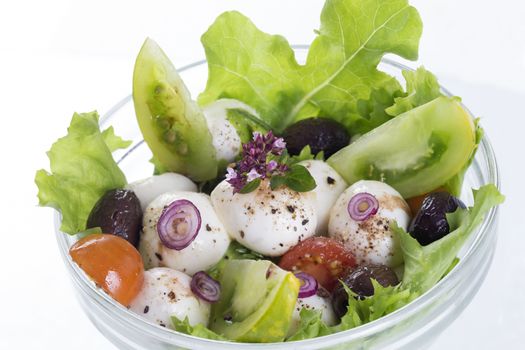 salad with mozzarella, tomatoes bloack olives and basil