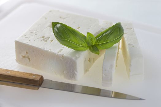 feta cheese cut in slices,  with basil