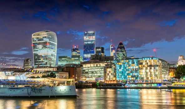 City of London. Stunning skyline at dusk with Thames river reflections.