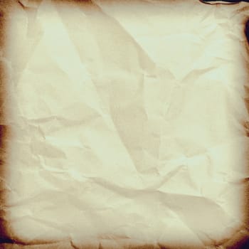 Crumpled paper background vignette space for text or image.Old paper texture