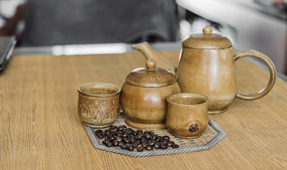 Soft focus image of coffee beans and coffee cups set on wooden background.Vintage style.(soft focus)