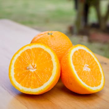 Slice of orange on wooden table.