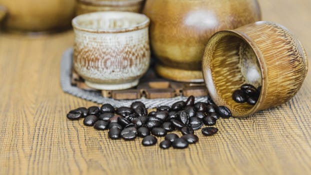 Soft focus image of coffee beans and coffee cups set on wooden background.Vintage style.(soft focus)