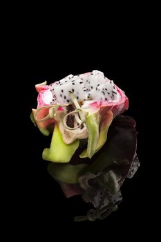 Dragon fruit isolated on black background. Tropical fruit salad.