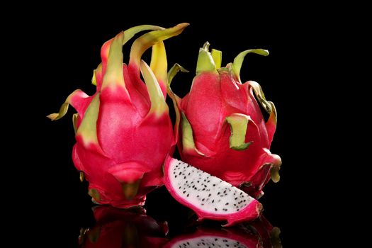 Dragon fruits isolated on black background. Pitaya, tropical fruits, minimal sparse style.