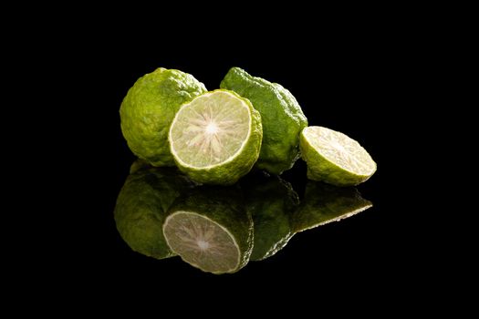 Ripe bergamot fruit on black background. Culinary cooking ingredient, tropical fruit bergamot orange.