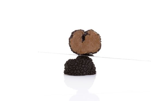 Cut truffles with knife isolated on white background. Luxurious culinary cooking ingredienets. 