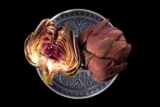 Fresh artichoke isolated on black background. Culinary healthy vegetable eating. 