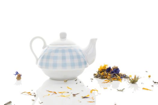 Delicious herbal tea mix with teapot isolated on white background. Healthy tea drinking. 