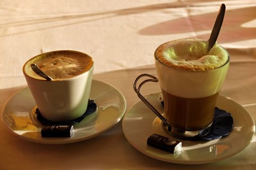 Coffee end Latte macchiato with small chokolate