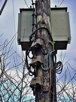 Wooden Electricity Pole with high voltage cables and Junction Boxes