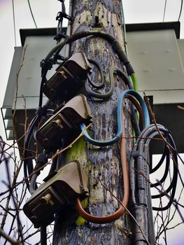 Wooden Electricity Pole with high voltage cables and Junction Boxes