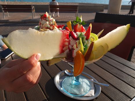 Fruit salad with ice cream in glass