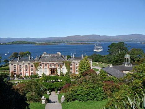 Bantry House in Ireland with sailboat in behind