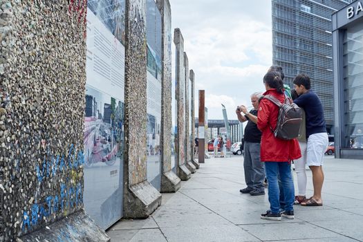 BERLIN, GERMANY - JULY 08: Tourists looking at remaining segments of the wall in central East Berlin. July 08, 2015 in Berlin.