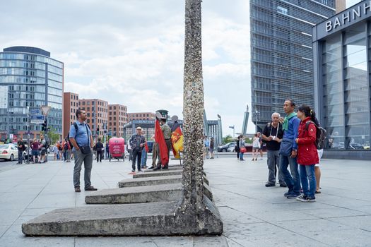 BERLIN, GERMANY - JULY 08: Tourists looking at remaining segments of the wall in central East Berlin. July 08, 2015 in Berlin.
