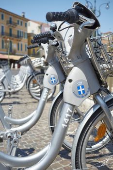 VERONA, ITALY - JULY 11: Low angle cropped shot the city's cycle hire bicycles parked in line. July 11, 2015 in Verona.