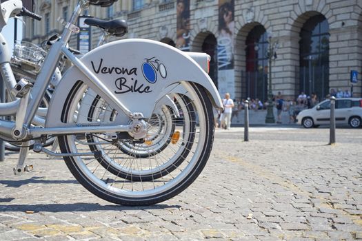VERONA, ITALY - JULY 11: Low angle cropped shot the city's cycle hire bicycles parked in line. July 11, 2015 in Verona.