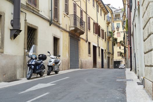 VERONA, ITALY - JULY 13: Low angle shot of street with scooters parked. July 13, 2015 in Verona.