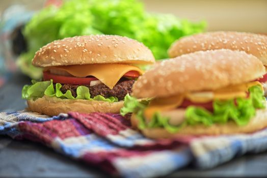Closeup of home made burgers on wooden table