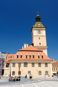 Brasov, Transylvania, Romania, 6th July 2015: Brasov Council Square is historical center of city, people sitting and walkinng near old Town Hall