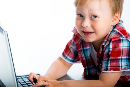 The little blue-eyed boy with a laptop