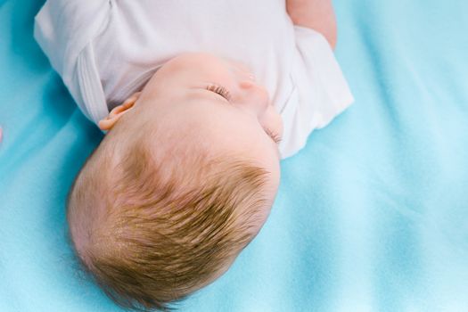 beautiful baby on a blue blanket. studio