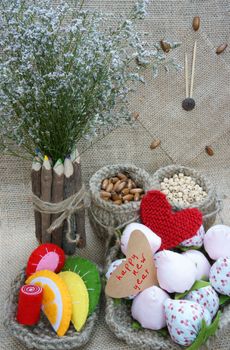 Handmade with love background, vintage style, amazing design with flower pot, knitted basket from burlap, fibre strawberry, colorful hand made fruit and cake