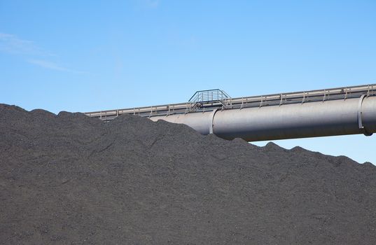 View at black coal deposit with transporter