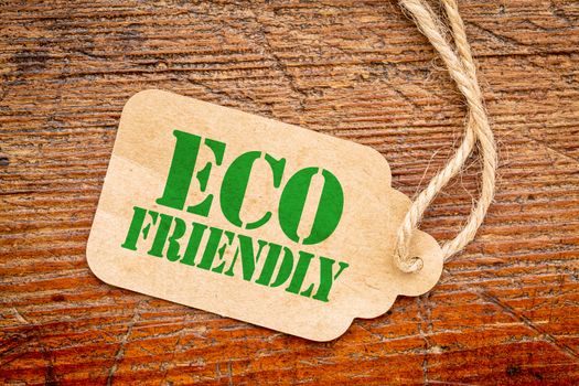 eco friendly  sign a paper price tag against rustic red painted barn wood - shopping concept