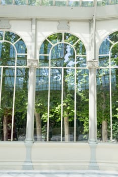 The Crystal Palace is located in the heart of the buen retiro park in Madrid in front of a lake