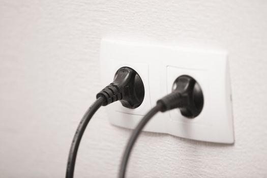 Close-up view of electric outlets with power cables